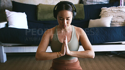 Buy stock photo Home, meditation and woman with headphones, calm or routine for mindfulness, yoga and self awareness. Streaming, music and inner peace on floor, namaste and person with tech and wellness in apartment