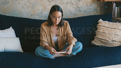 Buy stock photo Pregnancy test, result and woman on sofa with reading, maternity or wait in fertility outcome. Health, check and female person in home with medical stick, IVF and motherhood kit expectations.
