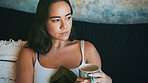 Coffee, thinking and woman in home in morning for reflection, thoughtful and wondering. House, relax and person on sofa with tea, drink and beverage for daydreaming, nostalgia and calm on weekend