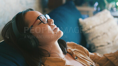 Buy stock photo Music, relax and weekend with woman on sofa in living room of home for me time or wellness. Audio streaming, headphones and radio with cozy Asian person in apartment for break, recovery or rest