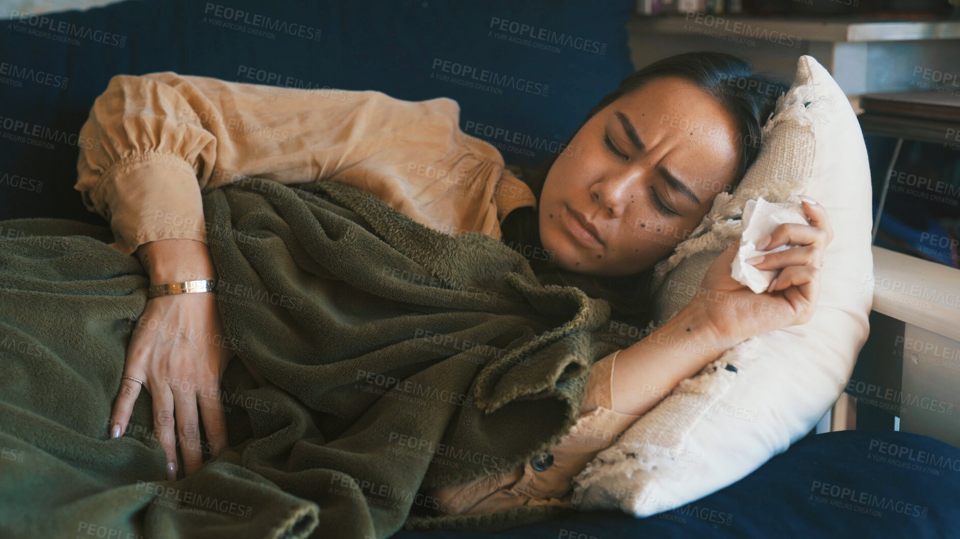 Buy stock photo Home, sick and woman on sofa, stomach pain and menstrual cramps in living room. Apartment, bowel ache and person on couch, resting and ibs with constipation, endometriosis and diarrhea with virus
