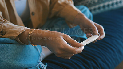 Buy stock photo Pregnancy test, hands of woman and couch with check, maternity or hope in fertility outcome. Health, waiting and female person in home with medical stick, IVF and motherhood kit expectations.