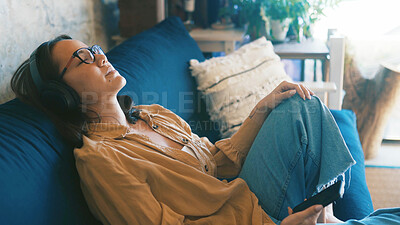 Buy stock photo Lounge, smartphone and woman with headphones, rest and listen to music with subscription and online. Streaming, audio and person with mobile for song selection, relax and calm with tech in house