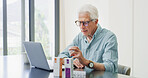 Medicine, pills and laptop with old man in home for dosage instruction, reading and side effects. Research, online pharmacy and medical information with senior person in apartment for prescription