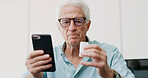 Medicine, pills and phone with old man in home for dosage instruction, reading and side effects. Research, online pharmacy and medical information with senior person in apartment for prescription