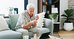Medical, prescription or old man on sofa with tablet, pill research or telehealth check for dose. Digital info, drugs or male person in house with tech, reading label for healthcare in retirement.