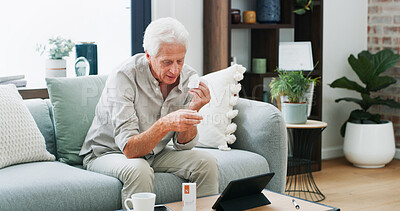 Buy stock photo Medical, prescription or old man on sofa with tablet, pill research or telehealth check for dose. Digital info, drugs or male person in house with tech, reading label for healthcare in retirement.