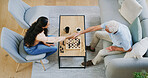 Chess, woman and grandpa handshake on sofa for congratulations, board game and mental challenge. Problem solving, above and people shaking hands for match win, thinking activity and checkmate in home