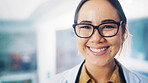 Portrait, doctor and woman with smile in office, physician and healthcare career in cardiology. Professional, cardiac health and specialist in hospital for wellness, glasses and medical services