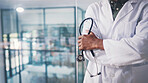 Stethoscope, hands and doctor with arms crossed in clinic, healthcare professional and cardiology career. Medical specialist, confident and man with health support, cardiac care and heart wellness.