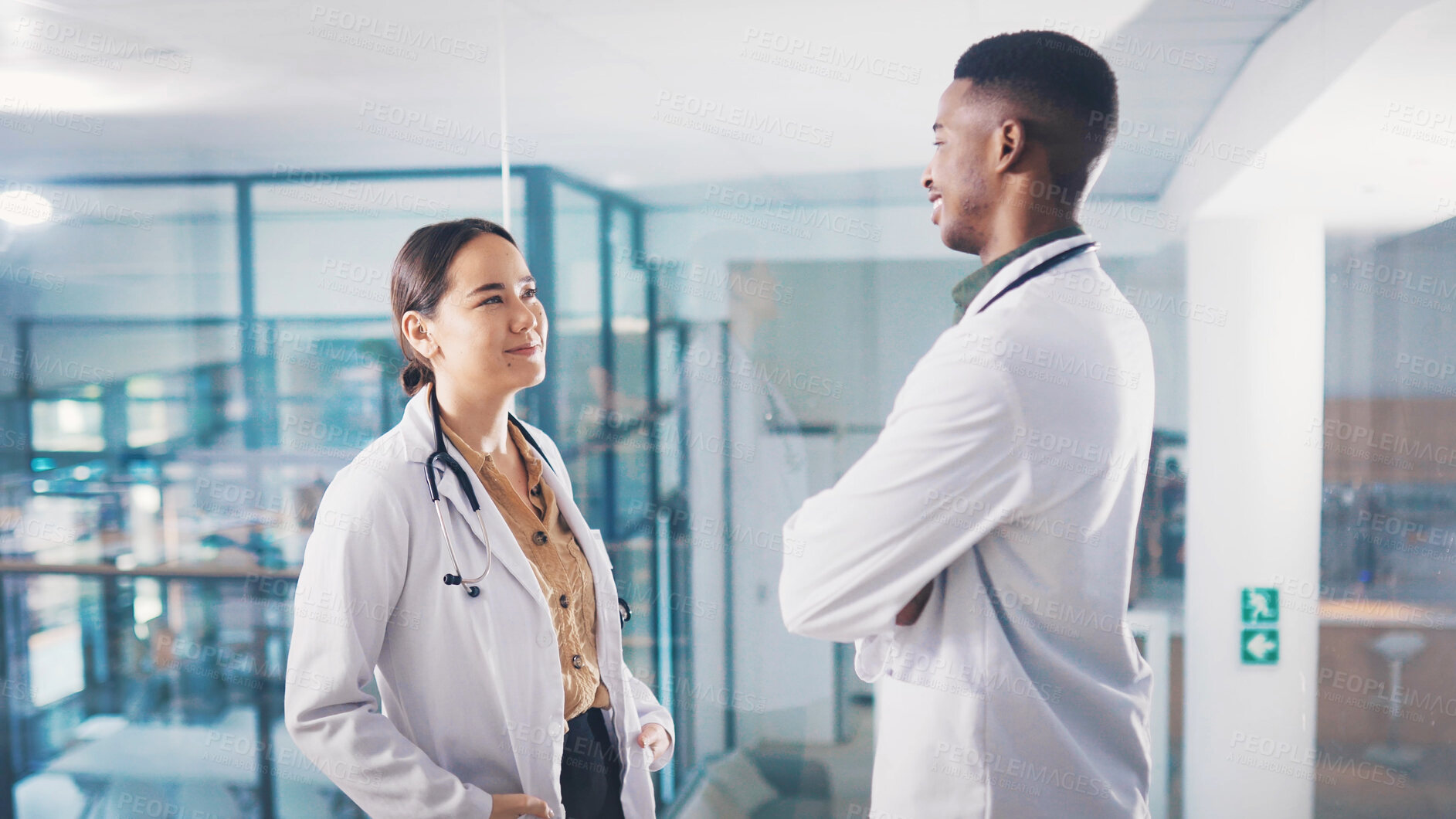 Buy stock photo Medical, student doctors and talking for healthcare collaboration, knowledge sharing and advice. Case discussion, teamwork and man with woman for planning clinical diagnosis, internship and helping.