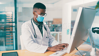 Buy stock photo Black man, doctor and typing on computer for medical history, report or insurance records. Desktop, mask and healthcare worker reading email for wellness, clinic schedule or research in office