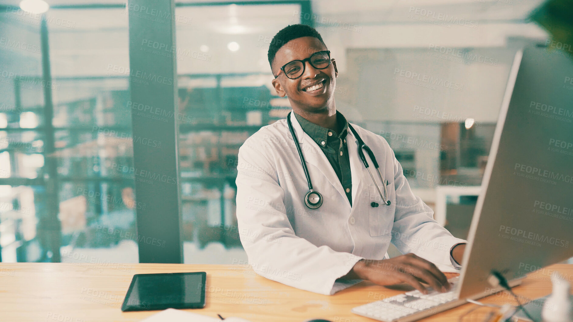 Buy stock photo Computer, healthcare and portrait with doctor black man at desk in hospital for results review. Medical, research and typing with medicine professional in office at clinic for agenda or schedule