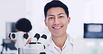 Portrait, scientist and Asian man in laboratory with microscope, medical research and development. Smile, science and face of person with microbiology equipment, professional and career pride
