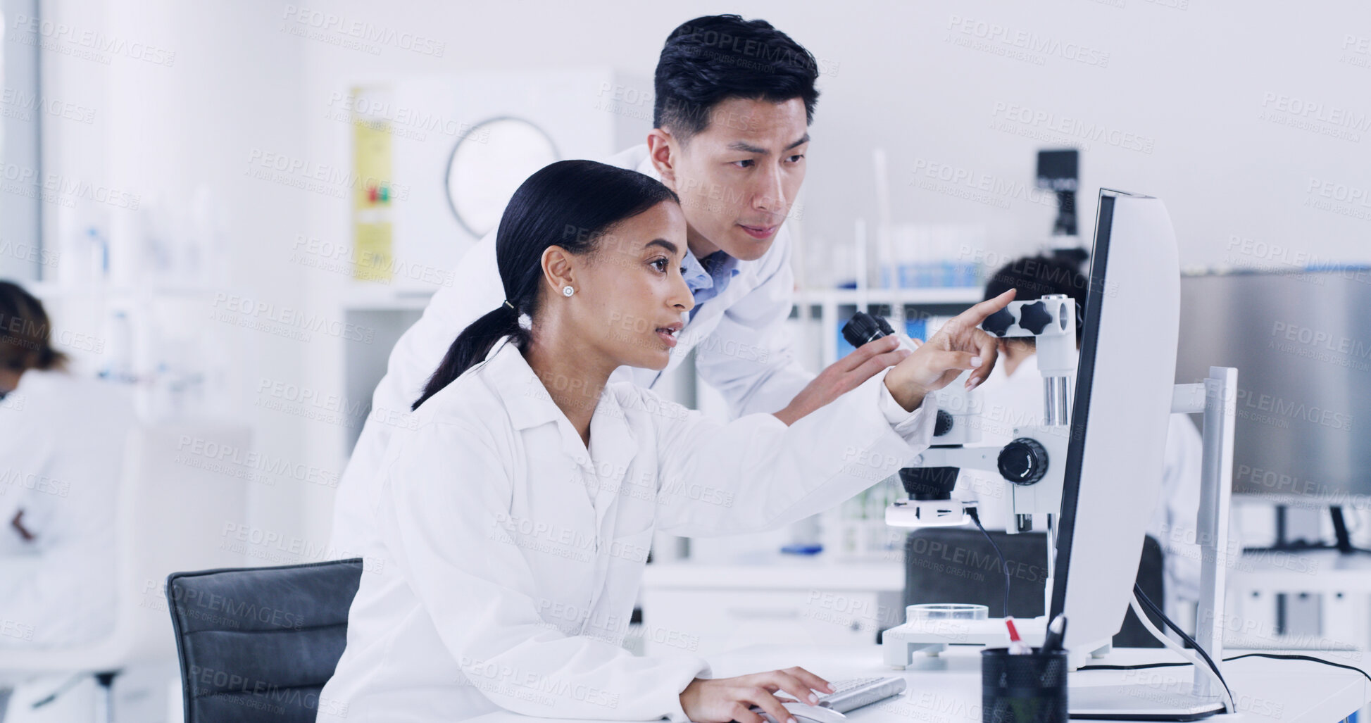 Buy stock photo Lab, scientists and people with computer, teamwork or medical research with tech to identify cancer. Woman, discussion and man with microscope for disease diagnosis, point and collaboration for cure