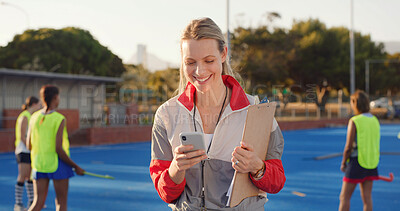 Buy stock photo Coach, hockey turf or happy woman with phone for match organization, event info or opponent approval. Planning, mobile or sport trainer with clipboard on field, game arrangement and local league team