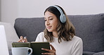 Woman, book and writing with headphones in home for elearning subscription, laptop and education. Person, computer and student with notebook, attention and online course in living room at apartment