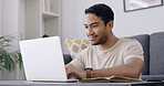 Man, student and laptop with typing in home, smile and review project for online course in lounge. Person, happy and computer with notebook, assessment or elearning with research on web at apartment