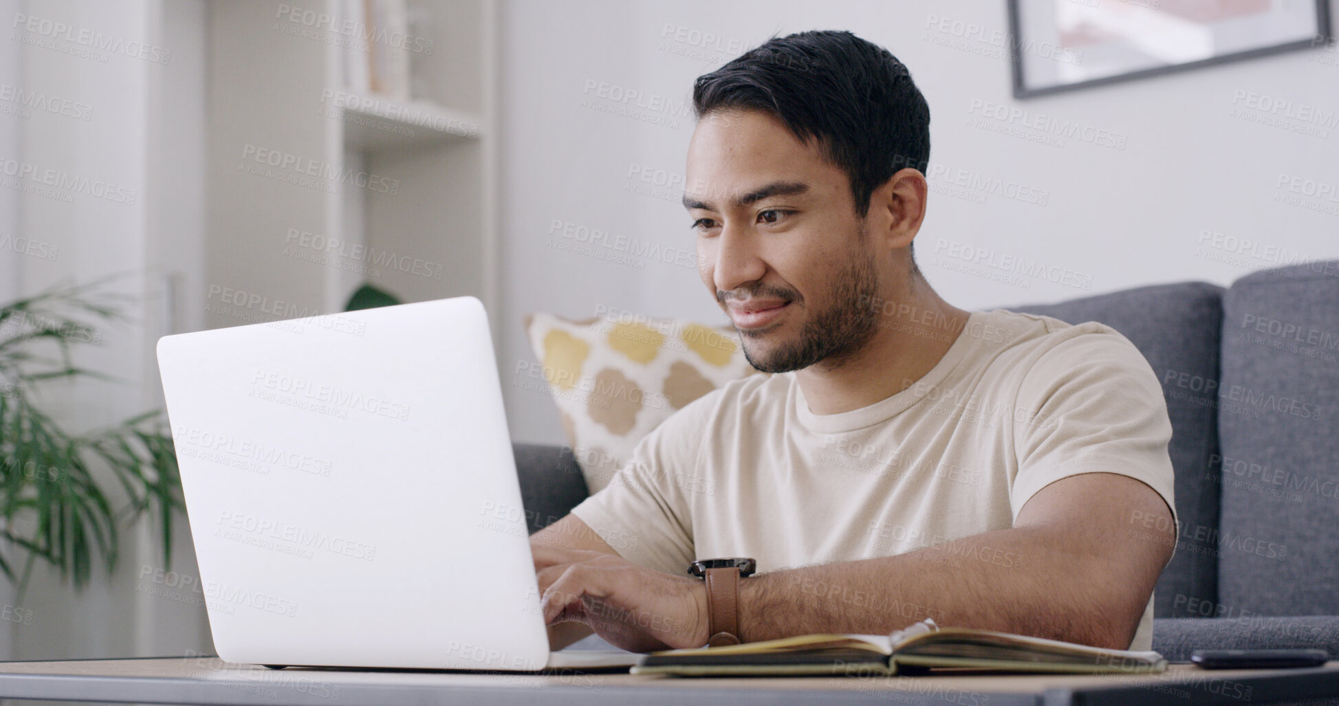 Buy stock photo Man, student and laptop with typing in home, smile and review project for online course in lounge. Person, happy and computer with notebook, assessment or elearning with research on web at apartment