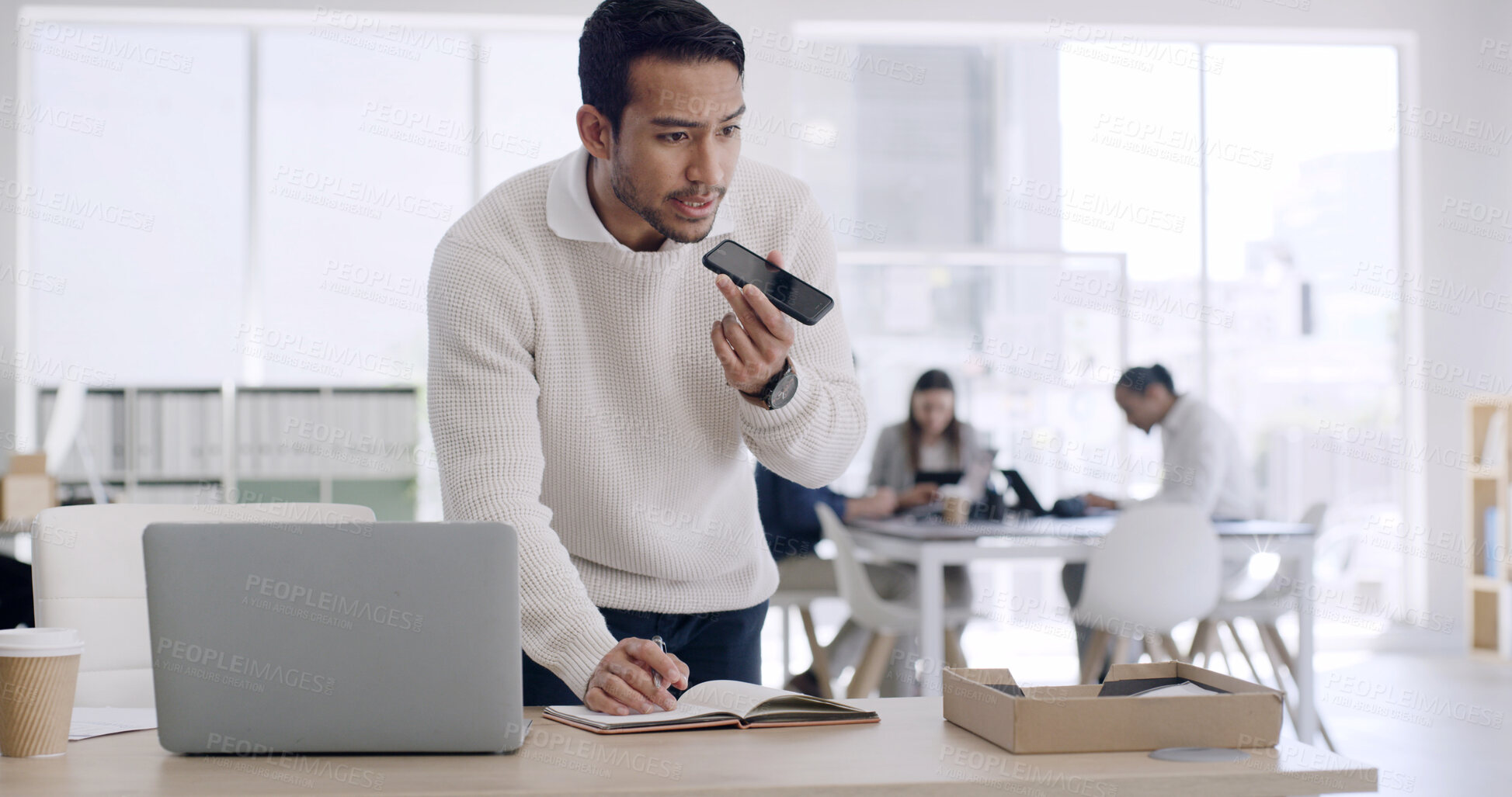 Buy stock photo Business, man and phone for voice message in office for feedback, schedule update and contact source. Person, laptop and audio recording for article advice, project reminder and chat for publication