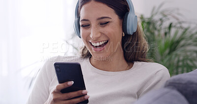 Buy stock photo Phone, laugh and woman with headphones in home, streaming service or funny video on internet. Mobile, music and happy person in living room for meme, online audio and listening to comedy podcast