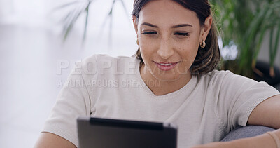 Buy stock photo Woman, relax and reading with tablet at house for browsing website, social media and notification. Person, rest and digital for surfing internet, streaming film and entertainment subscription on sofa