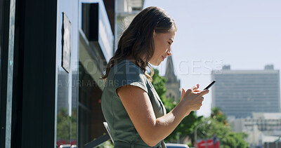 Buy stock photo City, phone and typing with business woman on balcony of office for social media or text message. App, connection and search with happy employee outdoor in urban town for mobile communication