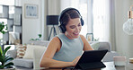 Headphones, woman and happy with tablet in home for streaming movie, online series or audiobook. Relax, person and smile with tech in apartment for watching video, social media and weekend break