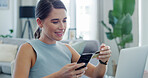 Phone, credit card and happy woman in home for payment, online shopping or virtual banking. Mobile, debit and person in living room with money for ecommerce, purchase and investment with savings