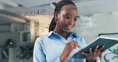 Buy stock photo Tablet, smile and black woman in office by glass wall for business, sales stats or metrics at night. Tech, reading and analyst with financial forecast, brainstorming chart and planning on overtime