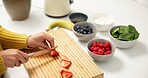 Person, hands and cutting fruit with board in kitchen for smoothie, nutrition or organic meal prep. Top view, health or nutritionist with ingredients or strawberry for dietary, wellness or vitamins