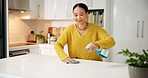 Happy, woman and cleaning counter with spray for germ disinfection, dirt removal and housekeeping. Home, person and chemical product in kitchen for household maintenance, hygiene and domestic chores