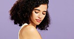 Beauty, hair care and woman in studio with natural cosmetology, aesthetic or space. Curly hairstyle, salon cosmetics and person with gen z model, texture or growth with selfcare on purple background