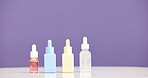 Bottle, serum and marketing for skincare in studio with mockup, space or promotion on purple background. Beauty, product and marketing for cosmetic care, dermatology selection and presentation