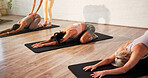 Yoga, childs pose and instructor with women in studio for health, relax and wellness exercise. Coach, mats and yogi with group of female people for pilates workout for fitness, calm and peace.