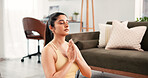Yoga, meditation and home with woman, hands together and calm with wellness, chakra and zen. Apartment, yogi or healthy person on floor, inner peace or stress relief with fitness or pilates in lounge