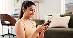Woman, phone and fitness with smile in home for online tips, workout app and social media. Internet tutorial, digital exercise guide and reading with person in living room of house for wellness