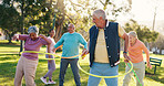 Senior people, class and exercise with hoop at park for active retirement, wellness or laugh. Elderly friends, ring and fitness outdoor, funny joke or workout for balance with group for cardio health