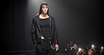 Man, model and catwalk with event for fashion show, garment collection or designer brand. Male person, crowd or paparazzi with clothing line or outfit for publicity or new aesthetic trend on runway