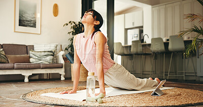 Buy stock photo Woman, yoga and stretching with tablet for online class, tutorial or fitness exercise in home. Active, female person or yogi with technology for cobra pose, virtual lesson or zen training in house