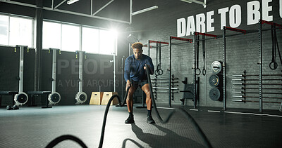 Buy stock photo Man, battle rope and workout in gym for cardio, exercise and body building for fitness. Intense routine, muscle and wellness with power for strength training, weight equipment and bicep challenge