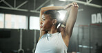Fitness, woman and thinking with stretching in gym for muscle relief, start workout and exercise. Flare, black person or arm warm up at health club for training preparation, flexibility or reflection