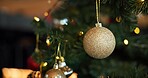 Christmas, decoration and festive with ball on tree in home for celebration, event or tradition. Background, holiday and wallpaper with bauble in apartment for aesthetic, vacation or winter season