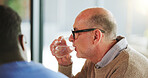 Drink, caregiver or old man in house with water, hydration or thirst in consultation break. Refreshment, h20 or male person in lounge with beverage, mineral liquid or detox in assessment rest.