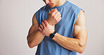 Fitness, wrist pain or man in studio with massage, training accident or emergency in muscle tension. Hurt, ache or athlete on white background with injury, stiffness or carpal strain in workout issue