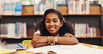 Happy girl, portrait and student with books in library for education, learning or literature. Child, kid or learner with smile or homework in bookshop or store for knowledge, wisdom or academic study