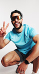 Athlete, fashion and man with sunglasses, studio and confident with cyberpunk aesthetic and fitness. White background, happy and person with shield eyewear, peace sign and futuristic Y2K athleisure