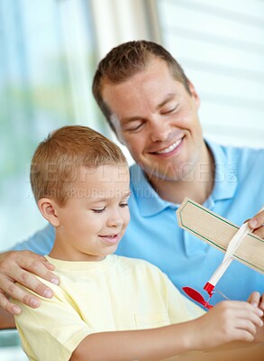 Buy stock photo Airplane, playing and boy with dad. toys and fun for bonding, relationship and creativity. Family, happy and child building model aeroplane with father for games, entertainment and relax in home