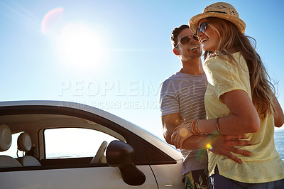 Buy stock photo Couple, adventure and road trip with car, hug and laughing on summer holiday, low angle and outdoor. Happy, man and bonding with woman in nature, embrace and journey with vehicle, sunshine or space