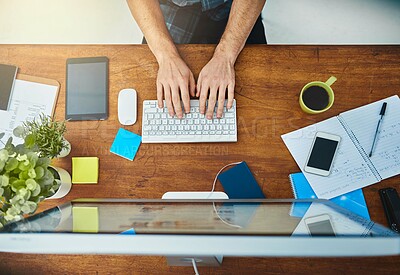 Buy stock photo High angle shot of an unrecognizable businessman working on his computer in the office
